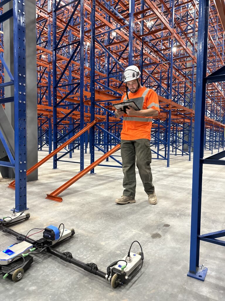 Durable Surfaces worker inspects floor flatness