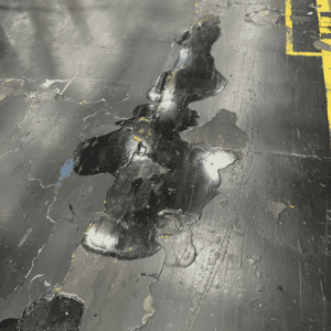 Patched area of concrete showing visible wear and damage. 